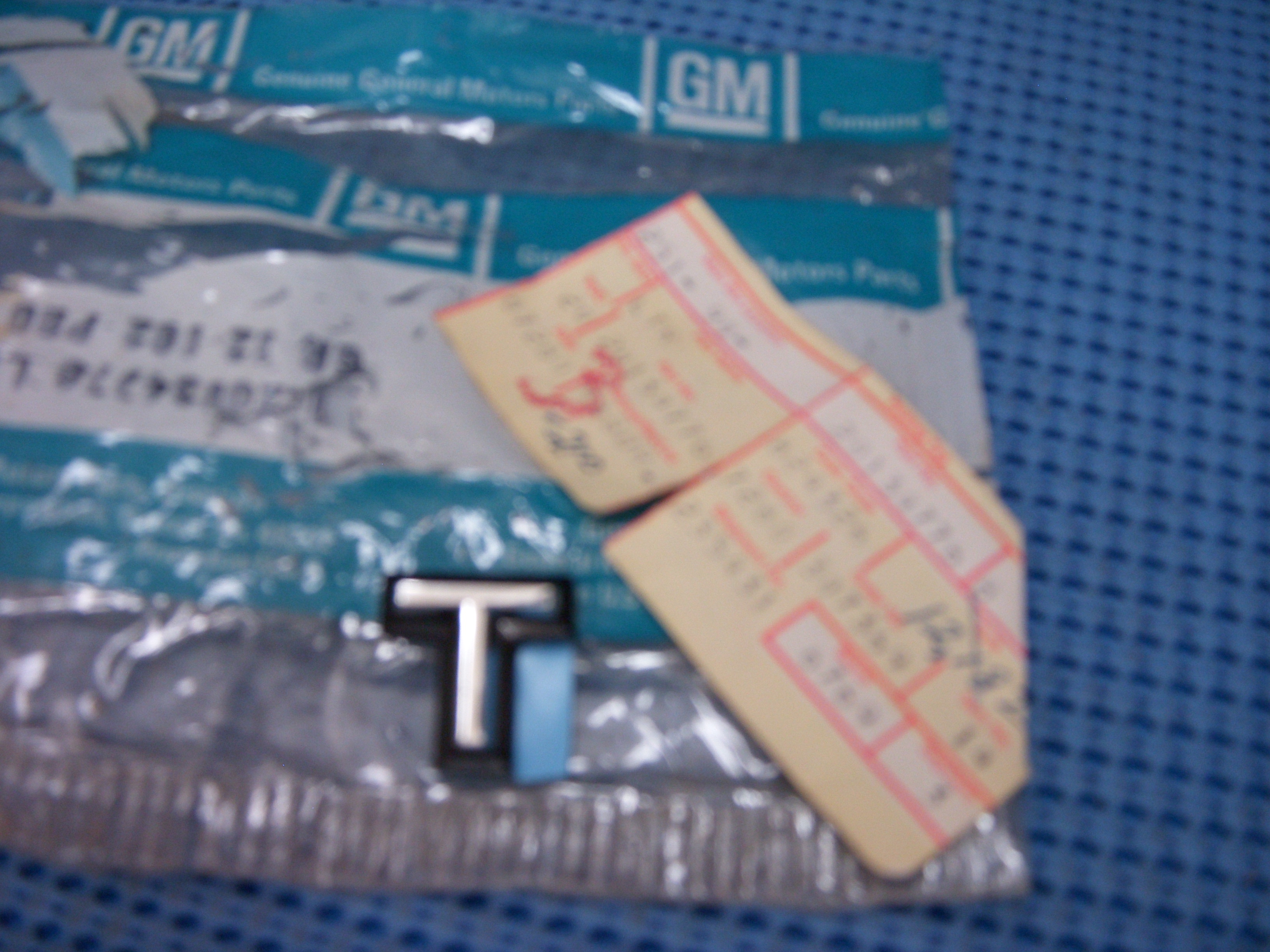 1984 Oldsmobile Rear Compartment Lid Script Letter "T" NOS # 20134776